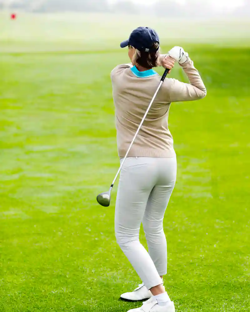 Female golfer wearing long sleeve