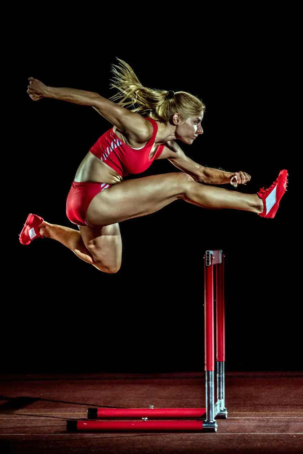 Why Do Female Track Athletes Wear Bikinis? All Reasons 2 Female athlete jump on the hurdle