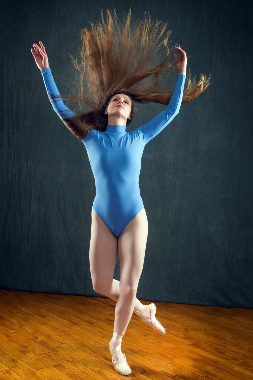 Girl performing gymnastic wearing a blue leotard