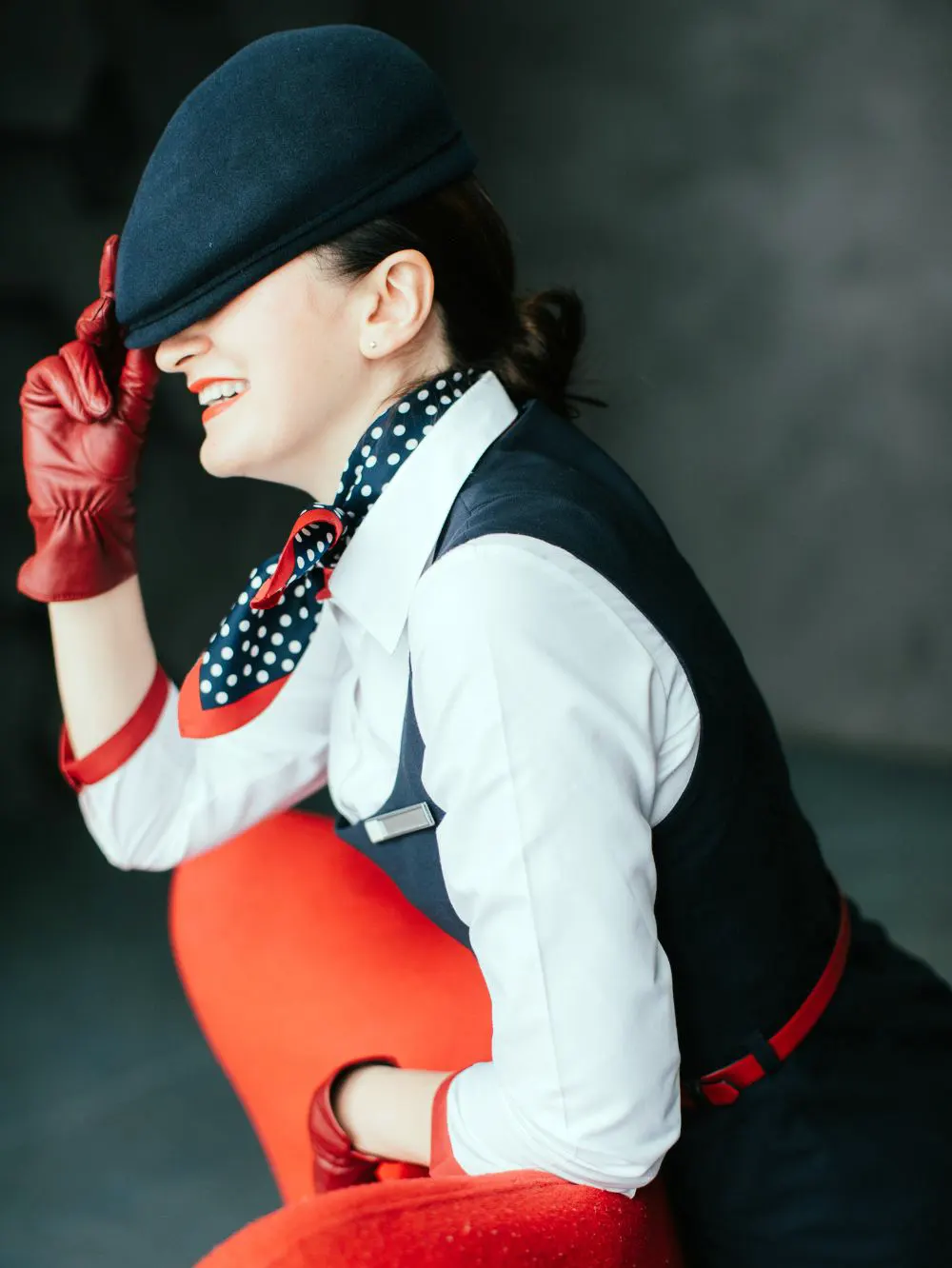 Fashionable woman standing wearing red gloves
