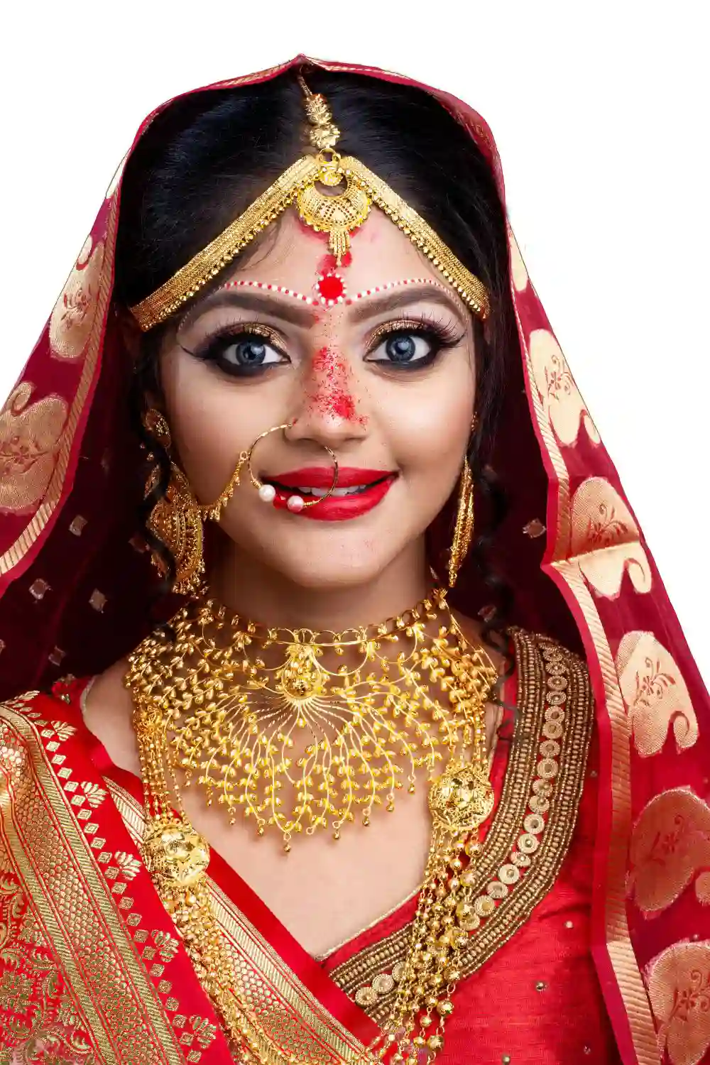 Indian or Bengali bride with sindoor in forehead wearing red sari and gold jewelry