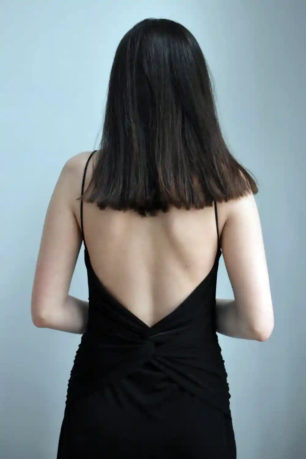 Woman Wearing a Black Backless Dress